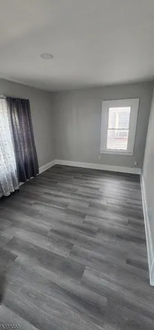 a view of an empty room and wooden floor