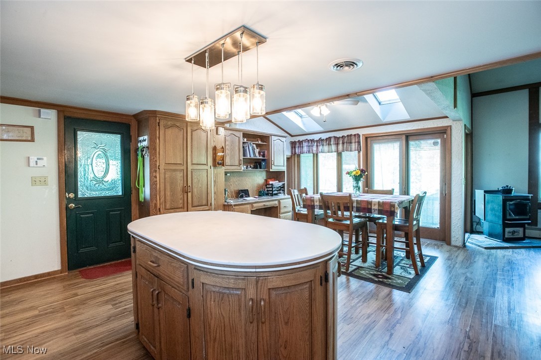 41180 Butternut Ridge Road Elyria, OH 44035 - Photo 22 of 50 Kitchen featuring a skylight, light wood finished floors, a center island, baseboards, and light countertops
