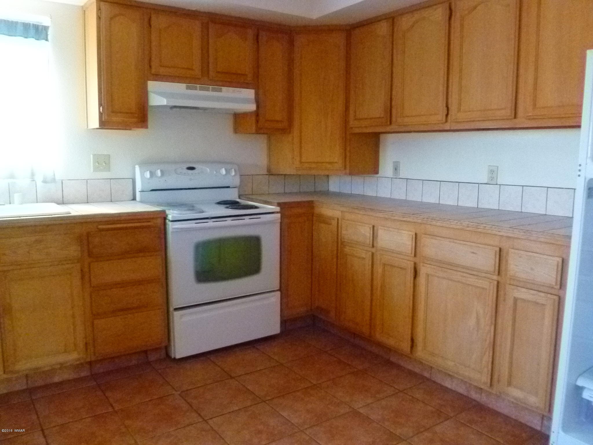 5218 Longhorn Road Snowflake, AZ 85937 - Photo 3 of 41 a kitchen with white cabinets and white appliances