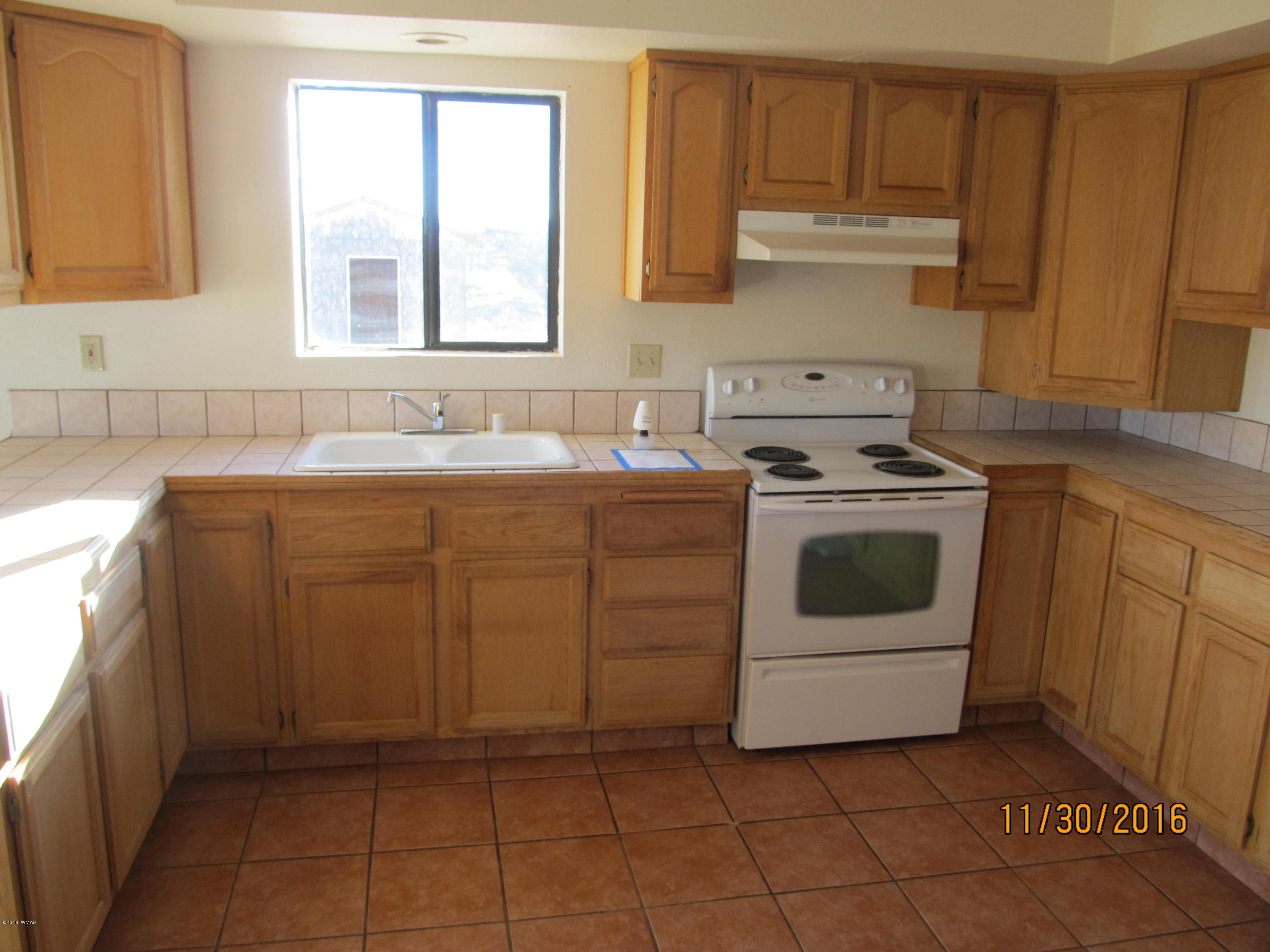 5218 Longhorn Road Snowflake, AZ 85937 - Photo 40 of 41 a kitchen with a stove sink and cabinets