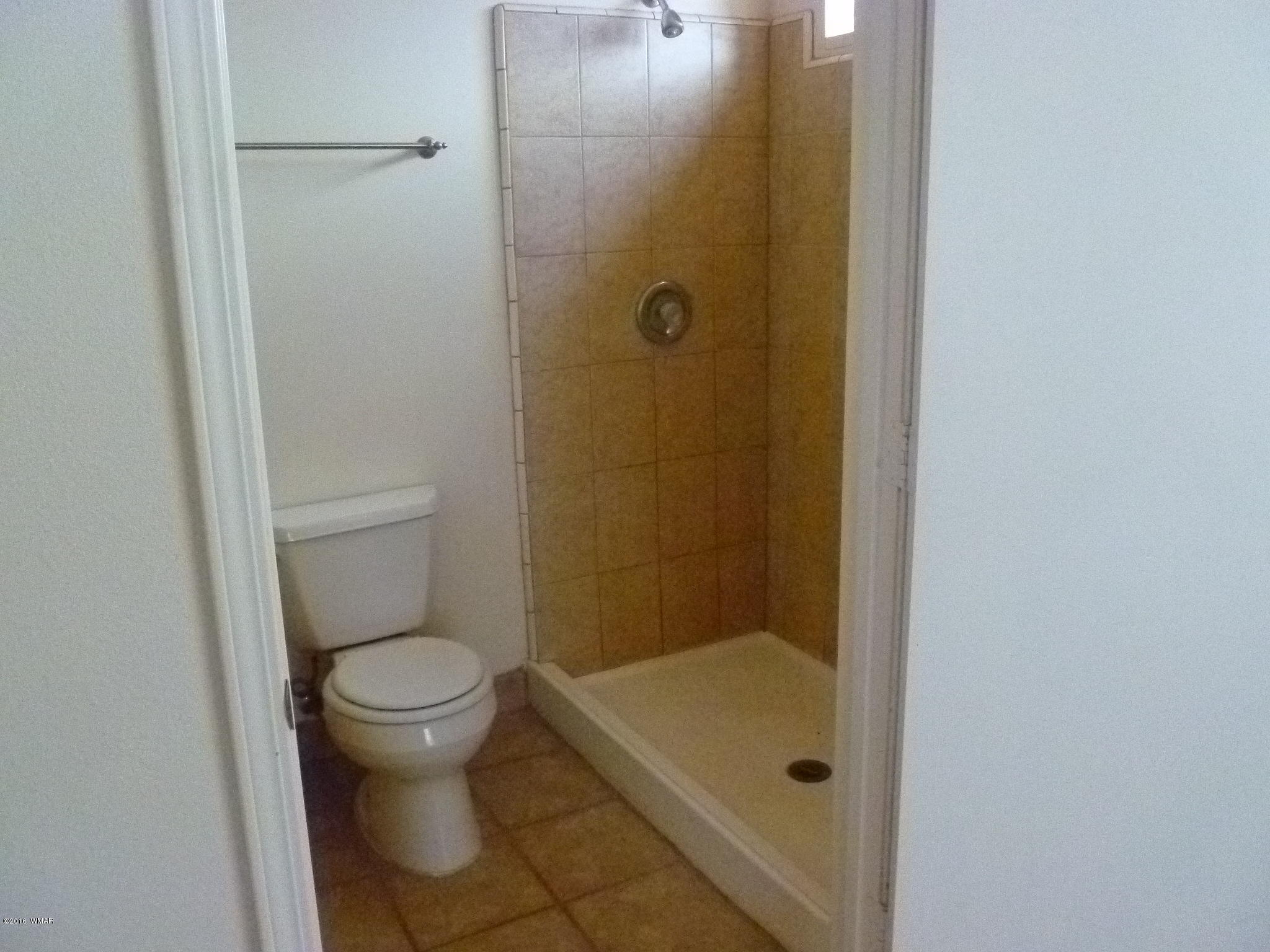 5218 Longhorn Road Snowflake, AZ 85937 - Photo 7 of 41 a bathroom with a granite countertop toilet and a shower
