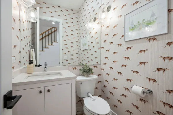 a bathroom with a sink toilet and a mirror