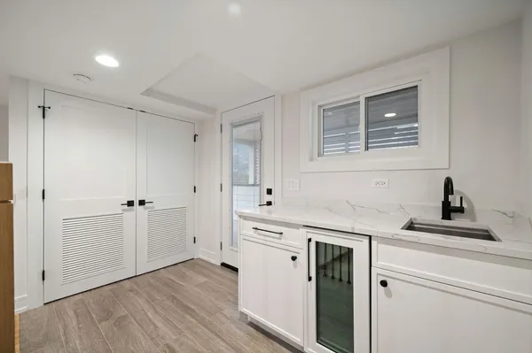 a kitchen with a sink cabinets and wooden floor