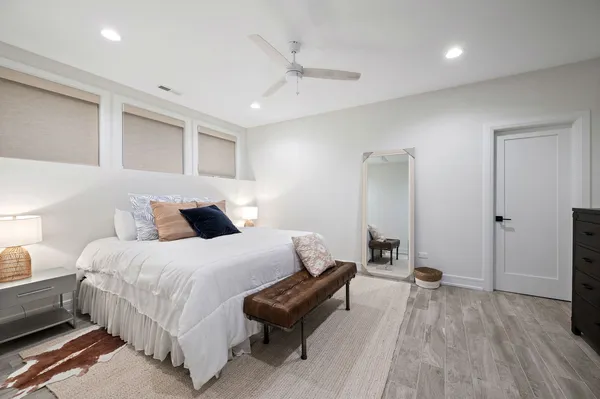 a bedroom with bed and a couch