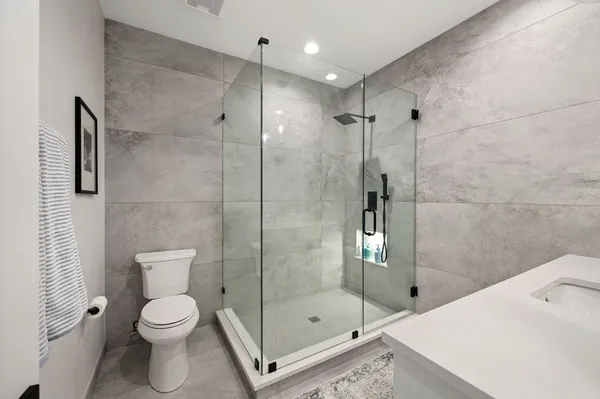 a bathroom with a shower a toilet and sink
