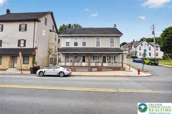 a view of a street that has couple of cars parked on the road