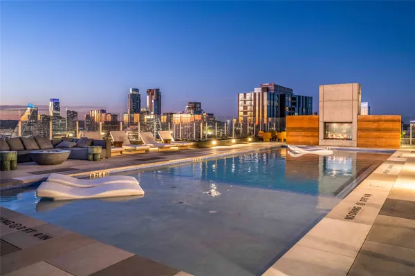 a view of a swimming pool with outdoor seating