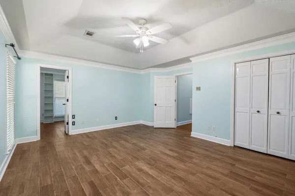 a view of an empty room with wooden floor