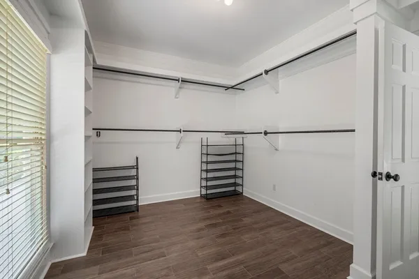a view of walk in closet with empty racks