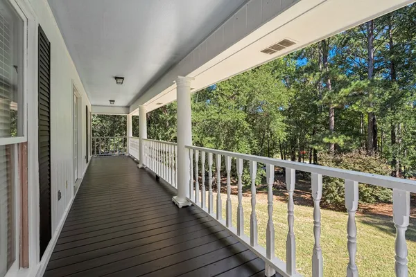 a view of a balcony with wooden floor