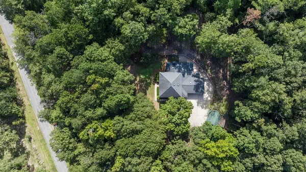 an aerial view of a house with a yard