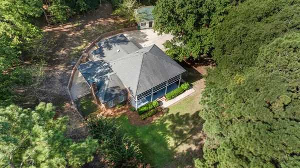 an aerial view of a house with a yard