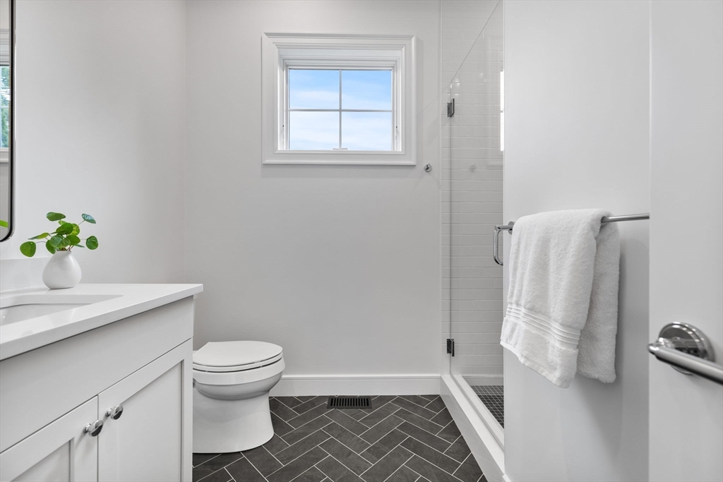 247 Broad Meadow Road Needham, MA 02492 - Photo 11 of 40 a bathroom with a granite countertop toilet and a sink
