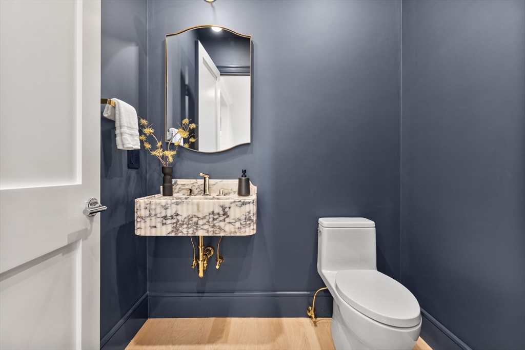 247 Broad Meadow Road Needham, MA 02492 - Photo 12 of 40 a bathroom with a toilet a sink and mirror