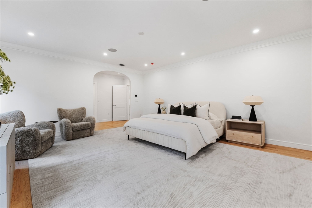 247 Broad Meadow Road Needham, MA 02492 - Photo 16 of 40 a spacious bedroom with a bed and a couch