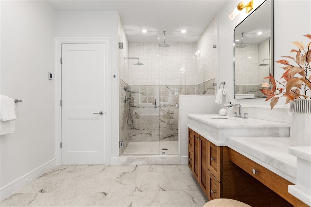 247 Broad Meadow Road Needham, MA 02492 - Photo 19 of 40 a bathroom with a granite countertop sink mirror and shower