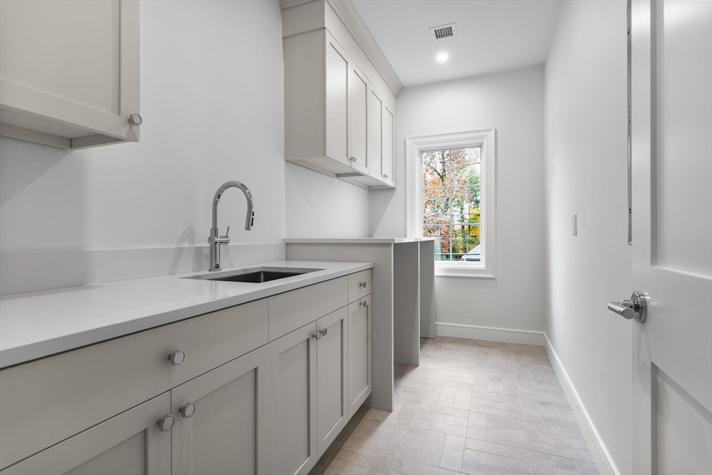 247 Broad Meadow Road Needham, MA 02492 - Photo 22 of 40 a kitchen with a sink cabinets and window