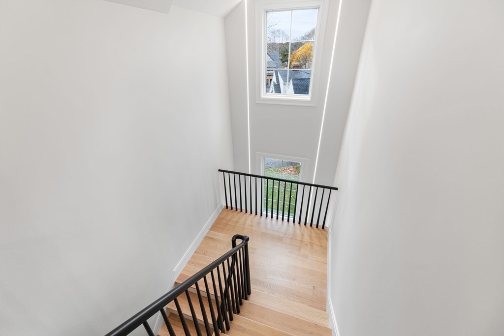247 Broad Meadow Road Needham, MA 02492 - Photo 25 of 40 a view of a hallway with wooden floor and a window