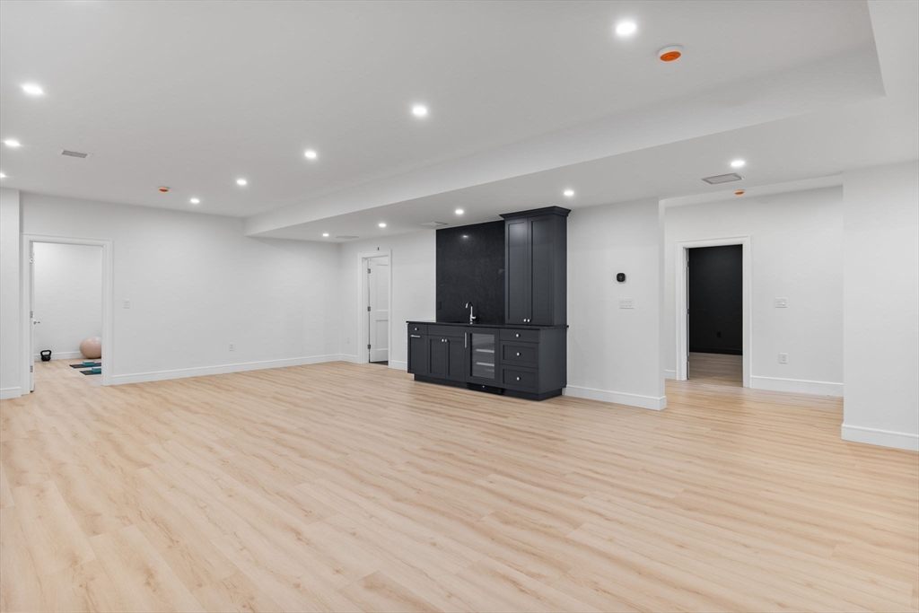247 Broad Meadow Road Needham, MA 02492 - Photo 27 of 40 a view of an empty room with wooden floor and a sink