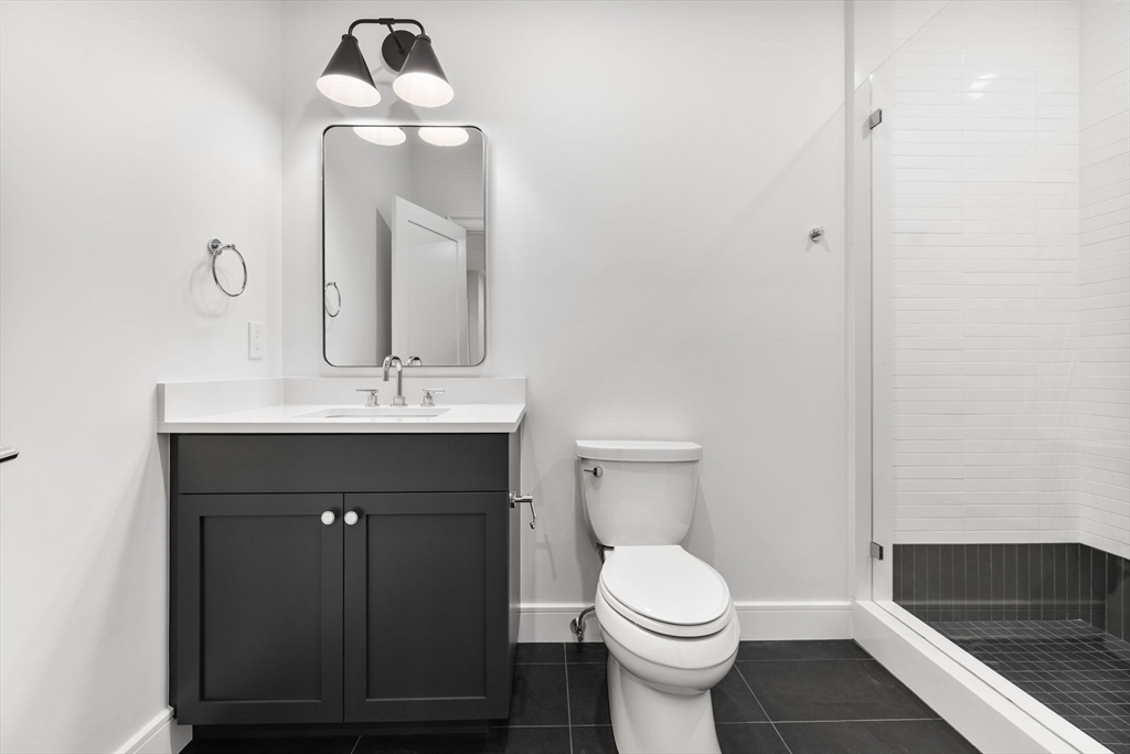 247 Broad Meadow Road Needham, MA 02492 - Photo 30 of 40 a bathroom with a toilet sink and mirror