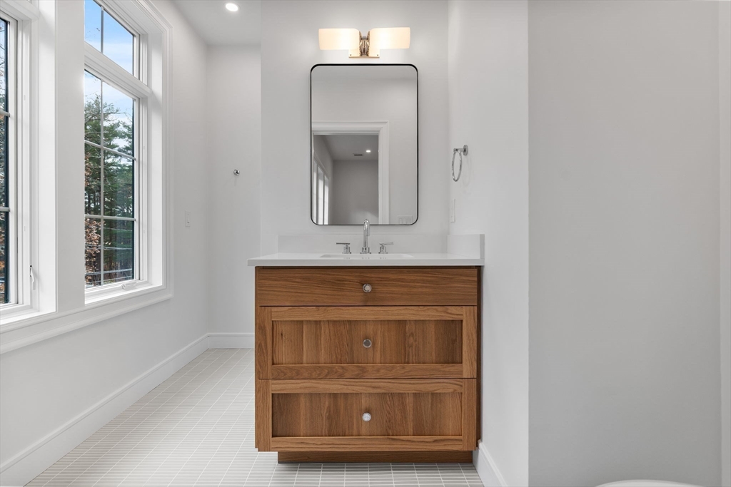 247 Broad Meadow Road Needham, MA 02492 - Photo 40 of 40 a bathroom with a sink a mirror and window