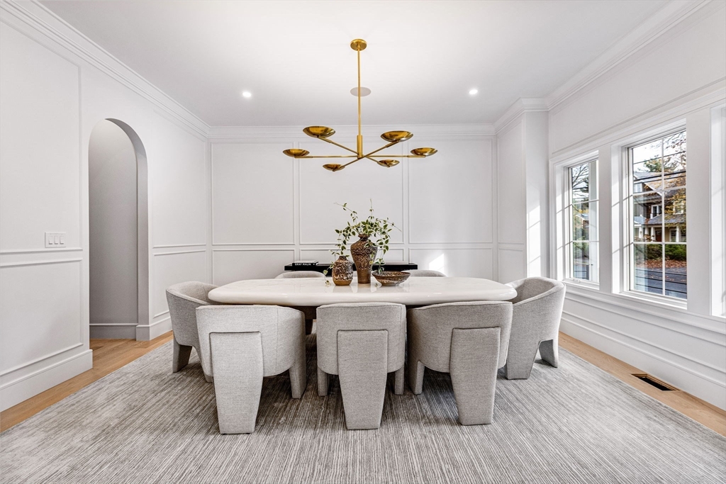 247 Broad Meadow Road Needham, MA 02492 - Photo 6 of 40 a dining room with furniture a chandelier and wooden floor