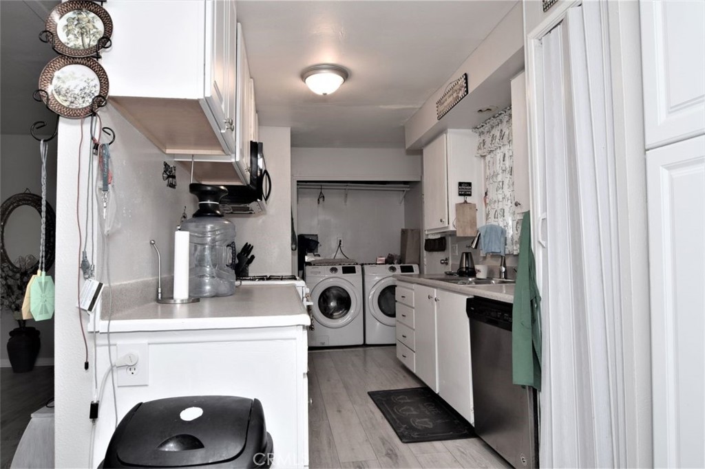 3255 East Avenue R, Unit 98 Littlerock, CA 92550 - Photo 8 of 12 a kitchen with a refrigerator a stove a washer and dryer