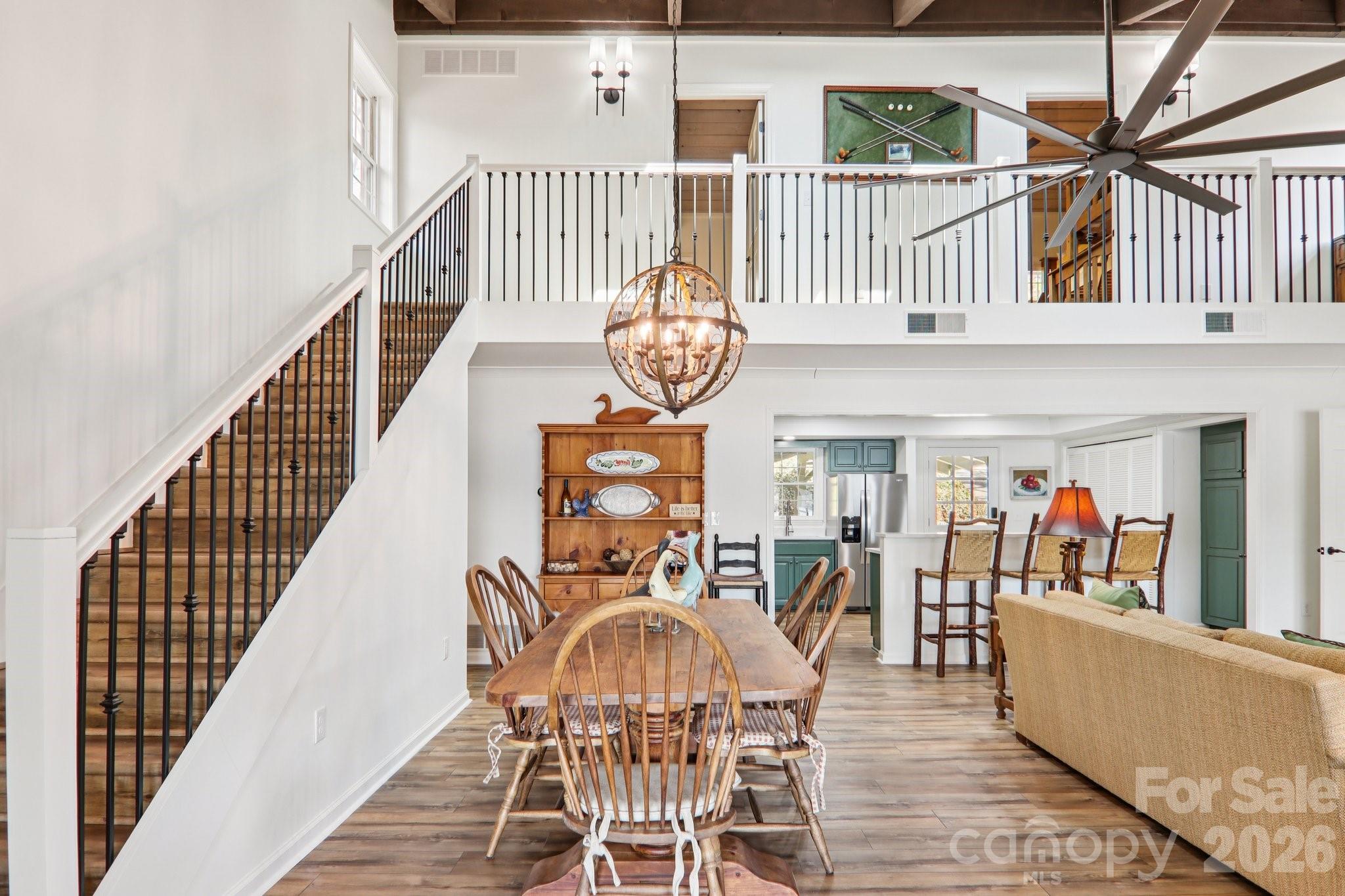 987 Cold Mountain Road Lake Toxaway, NC 28747 - Photo 17 of 42 a view of a dining room and hall with wooden floor
