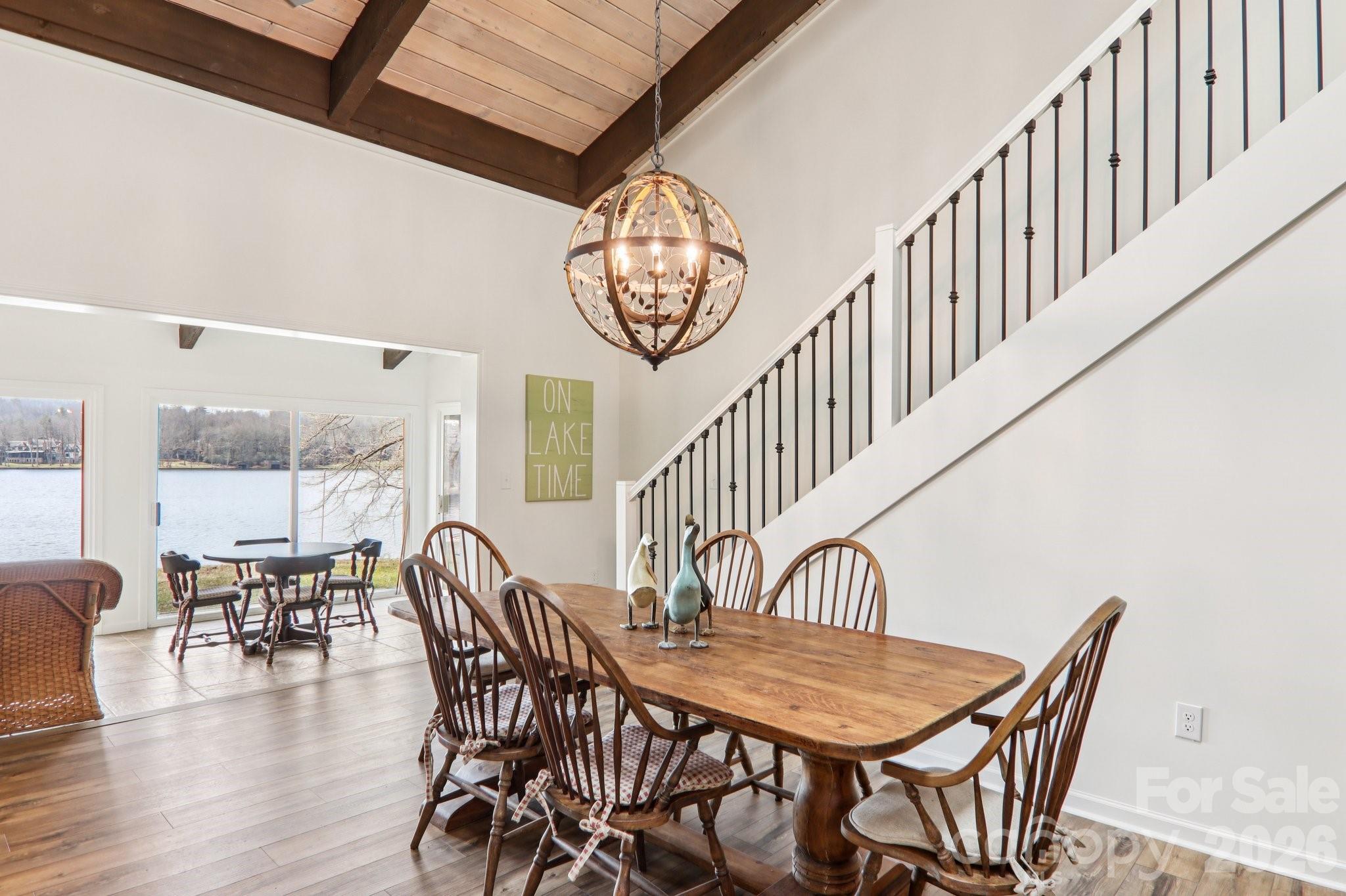 987 Cold Mountain Road Lake Toxaway, NC 28747 - Photo 18 of 42 a dining room with furniture a chandelier and wooden floor