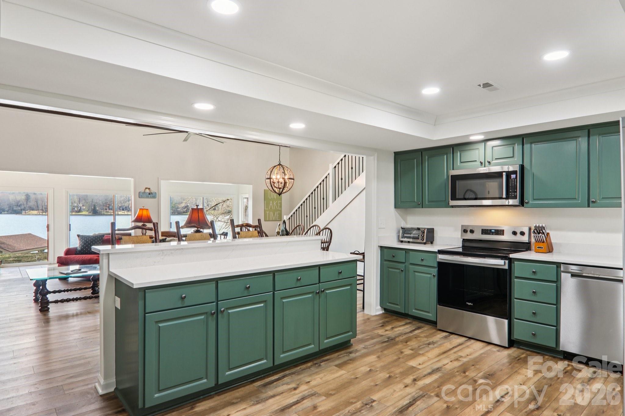 987 Cold Mountain Road Lake Toxaway, NC 28747 - Photo 19 of 42 a kitchen with lots of counter top space sink and a refrigerator