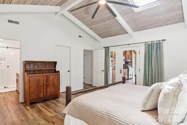a bedroom with a bed and wooden floor