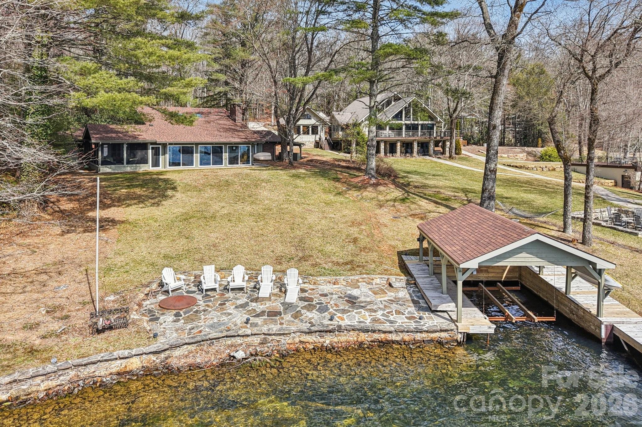 987 Cold Mountain Road Lake Toxaway, NC 28747 - Photo 3 of 42 a patio with table and chairs and potted plants