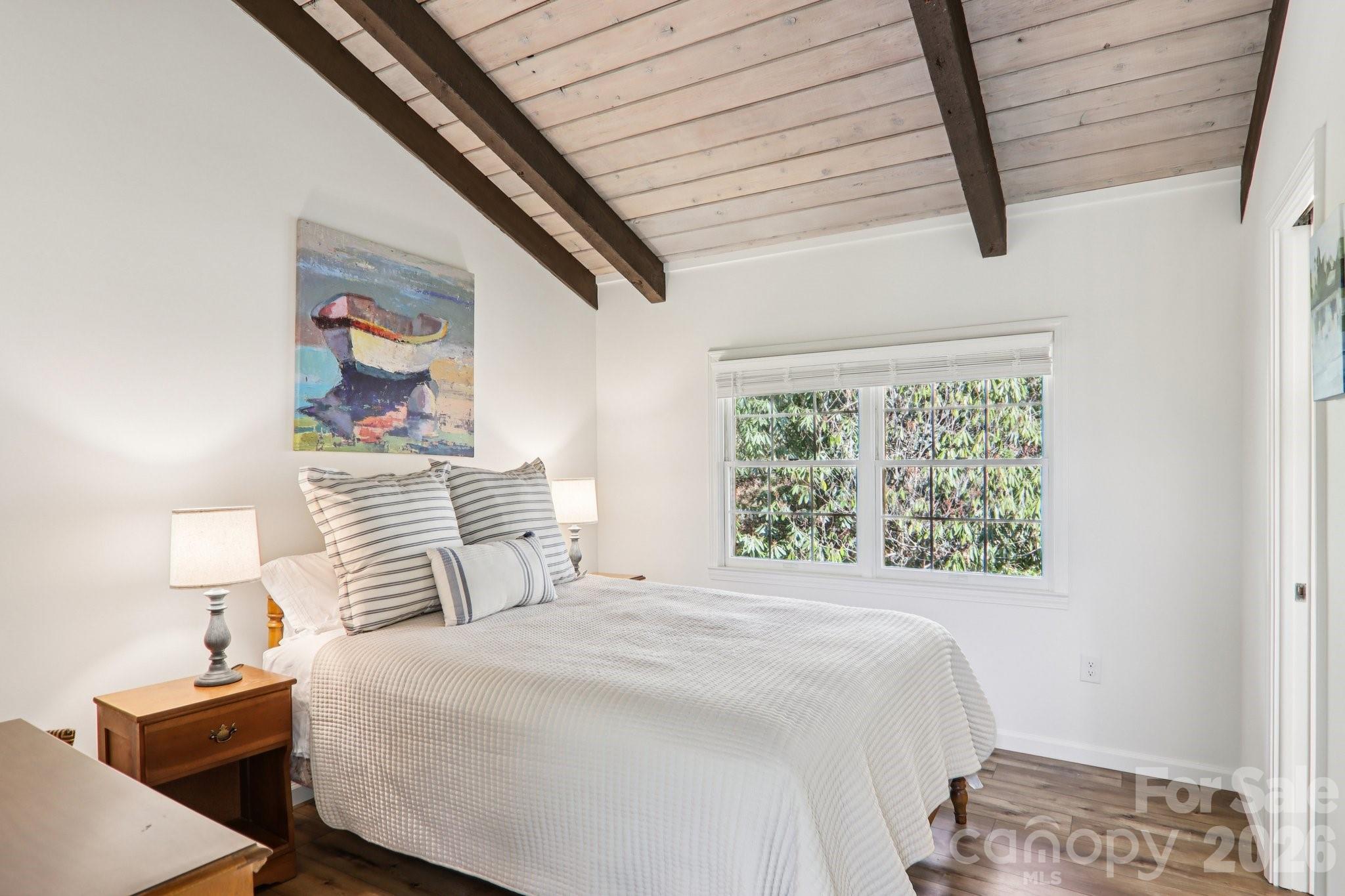 987 Cold Mountain Road Lake Toxaway, NC 28747 - Photo 33 of 42 a bedroom with a bed and a painting on the wall