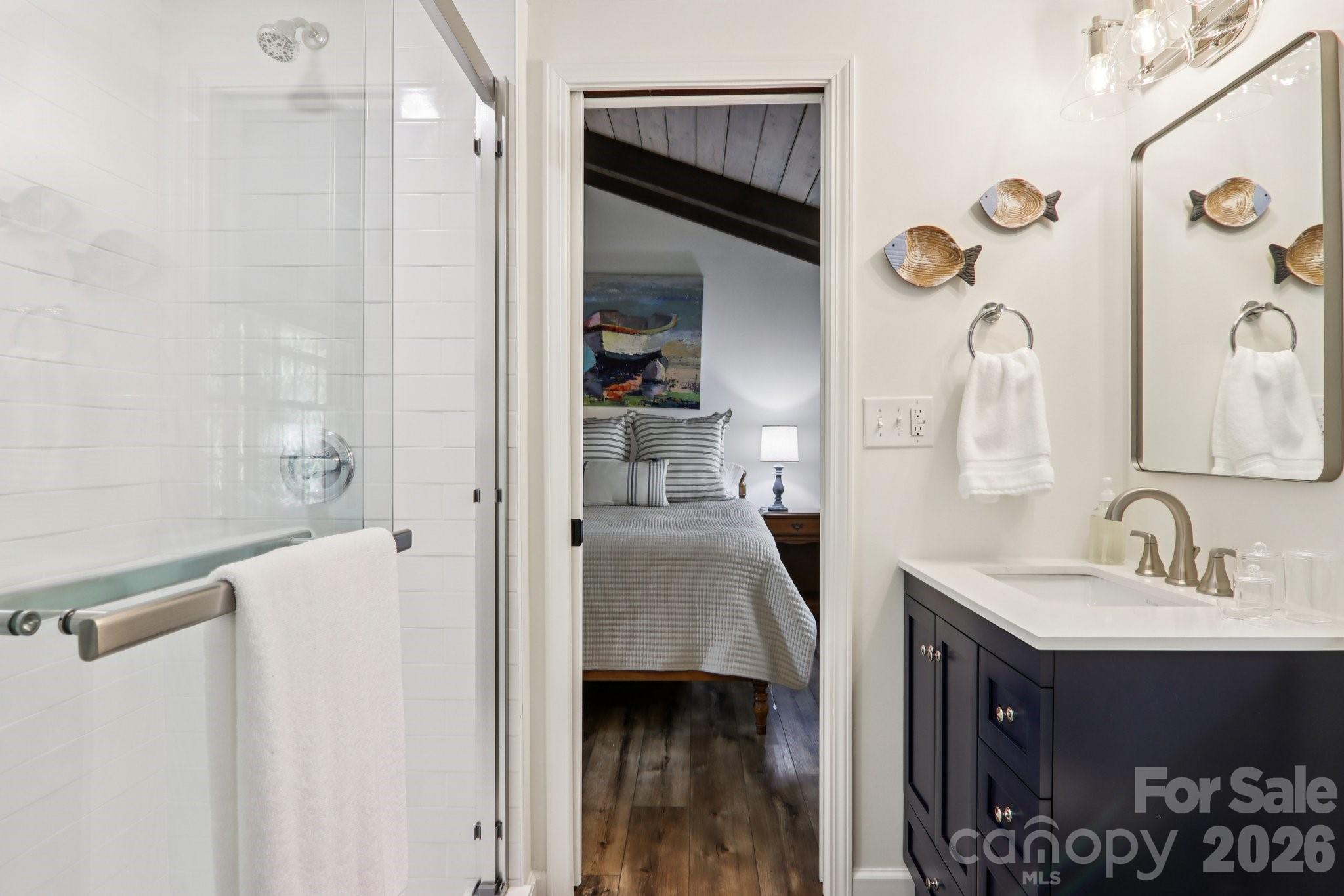 987 Cold Mountain Road Lake Toxaway, NC 28747 - Photo 35 of 42 a en suite bathroom with a sink and a mirror