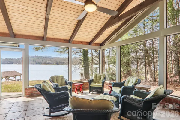 a living room with furniture and a floor to ceiling window