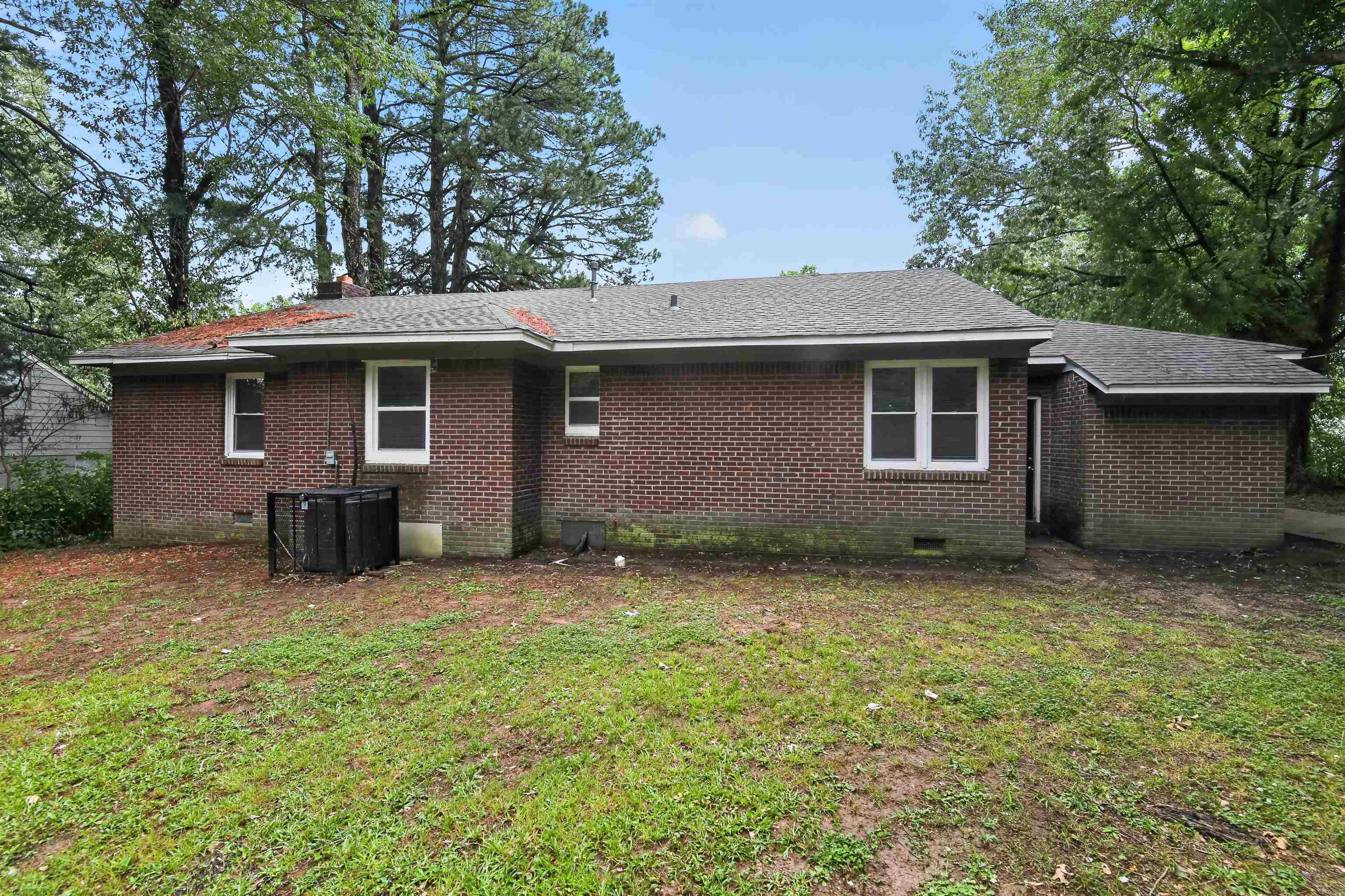 318 East Raines Road Memphis, TN 38109 - Photo 8 of 28 Brick exterior with multiple windows and a shingle roof