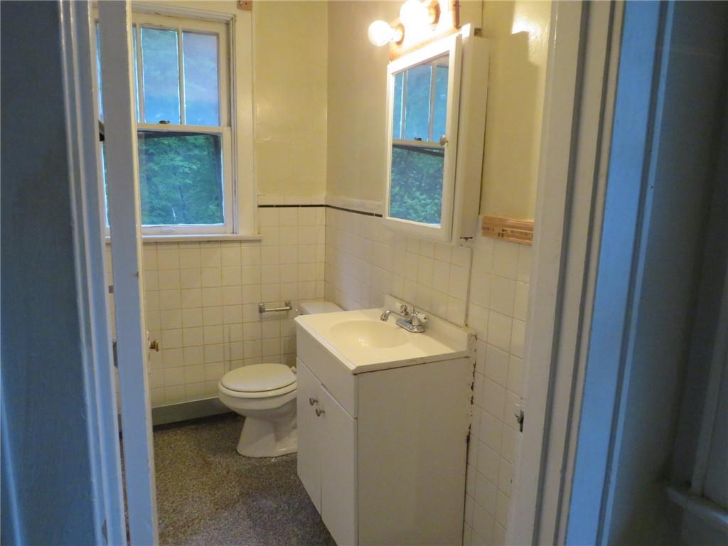 423 Braddock Road Pittsburgh, PA 15221 - Photo 28 of 36 a bathroom with a toilet sink and mirror