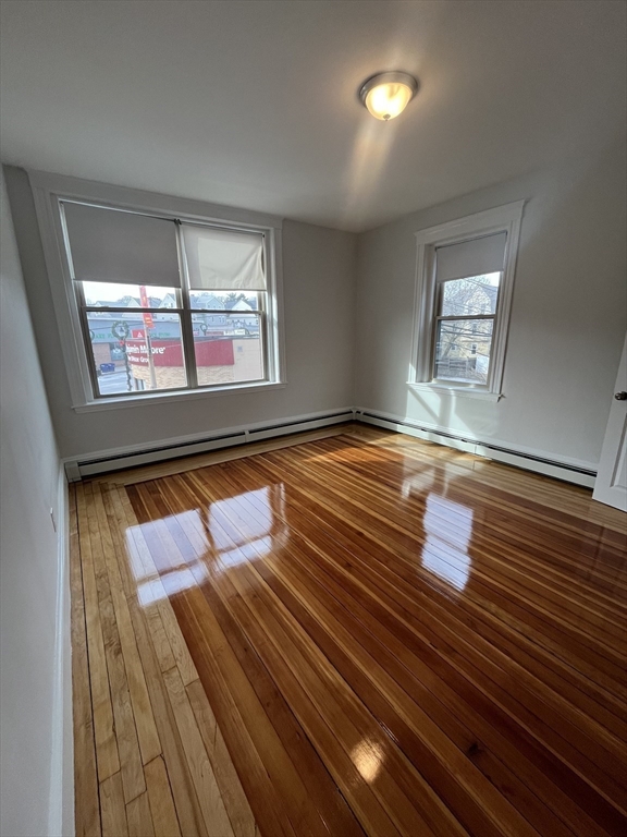 108 Bristol Road, Unit 1 Somerville, MA 02144 - Photo 13 of 30 a view of room with window and wooden floor