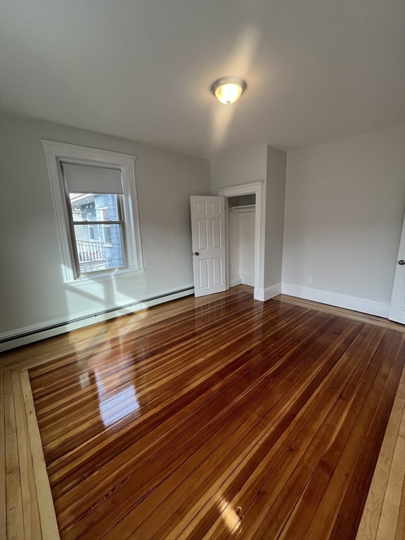 108 Bristol Road, Unit 1 Somerville, MA 02144 - Photo 15 of 30 a view of room with window and wooden floor