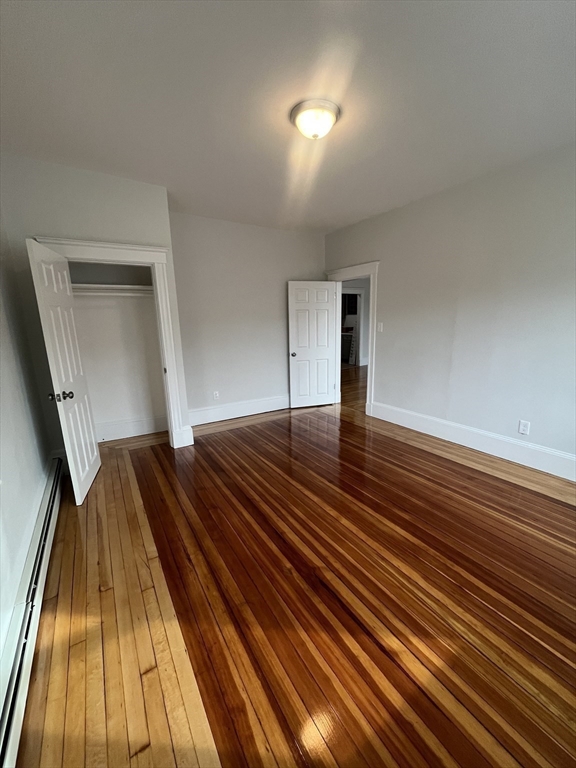108 Bristol Road, Unit 1 Somerville, MA 02144 - Photo 16 of 30 a view of empty room with wooden floor