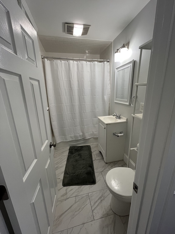 108 Bristol Road, Unit 1 Somerville, MA 02144 - Photo 22 of 30 a bathroom with a sink a toilet a mirror and shower