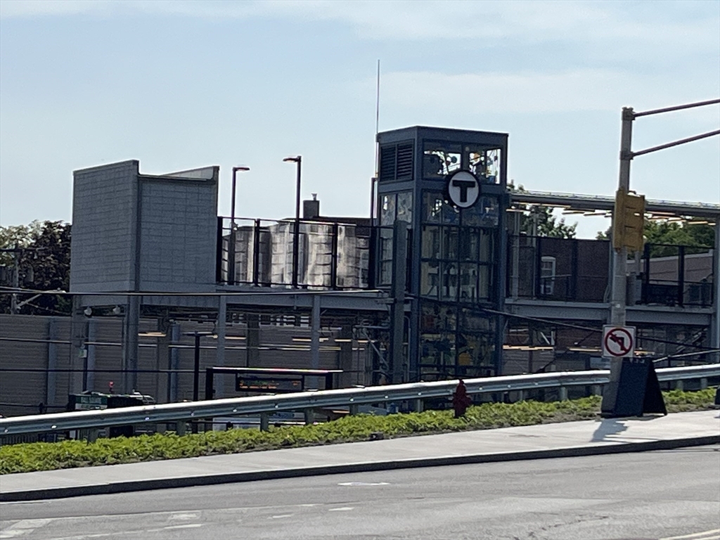 108 Bristol Road, Unit 1 Somerville, MA 02144 - Photo 24 of 30 a view of a brick house with a small yard and plants