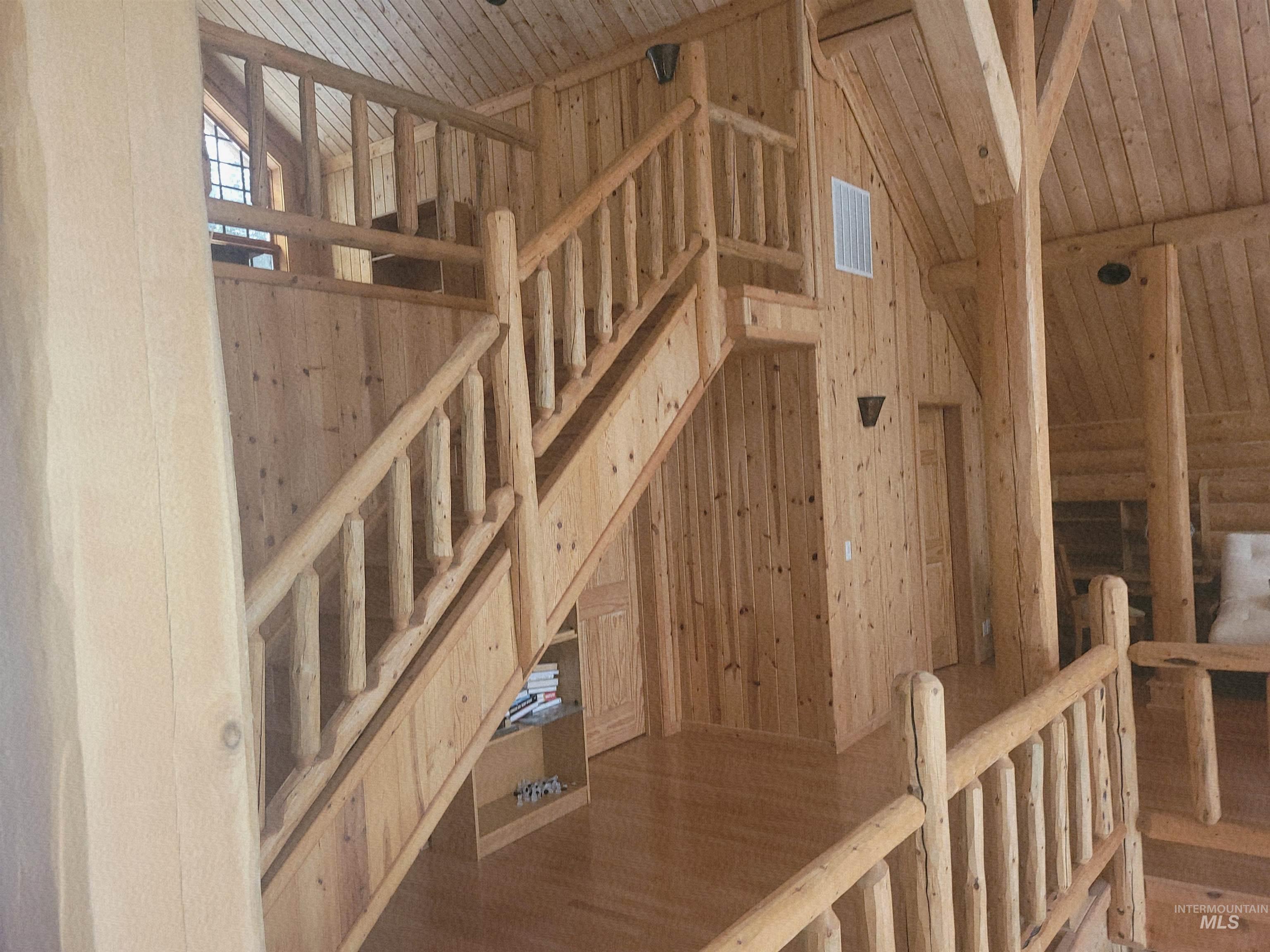 129 Copperhead Road Elk City, ID 83525 - Photo 2 of 28 Stairs featuring wood ceiling and wooden walls