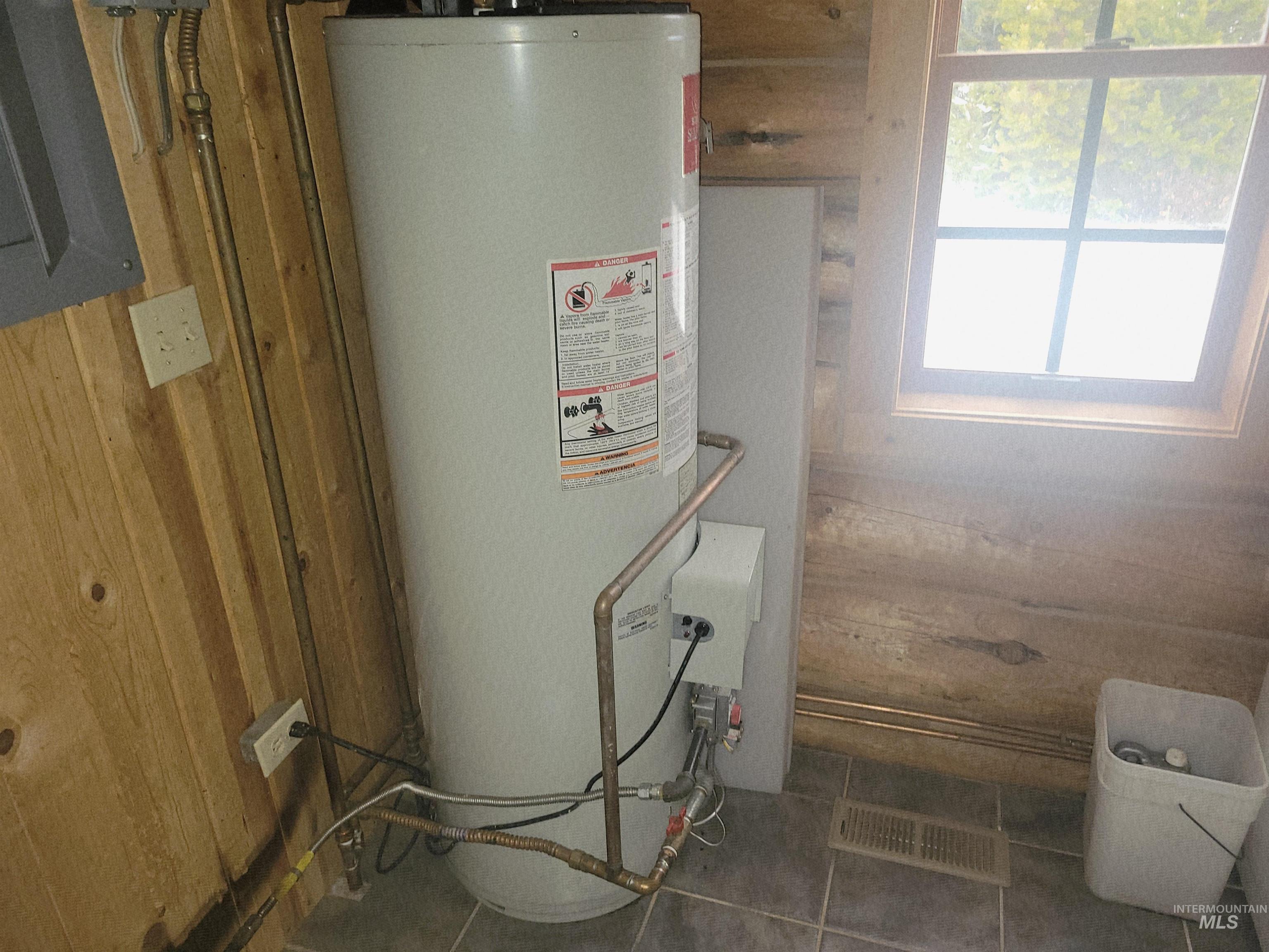 129 Copperhead Road Elk City, ID 83525 - Photo 26 of 28 Utilities featuring water heater and electric panel