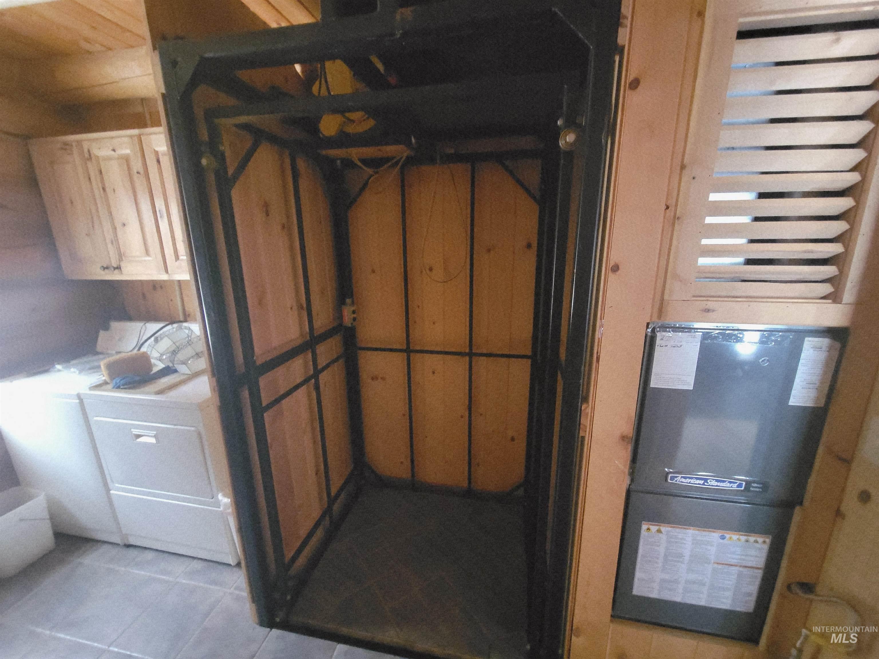 129 Copperhead Road Elk City, ID 83525 - Photo 28 of 28 Detailed view of wooden walls and washing machine and clothes dryer