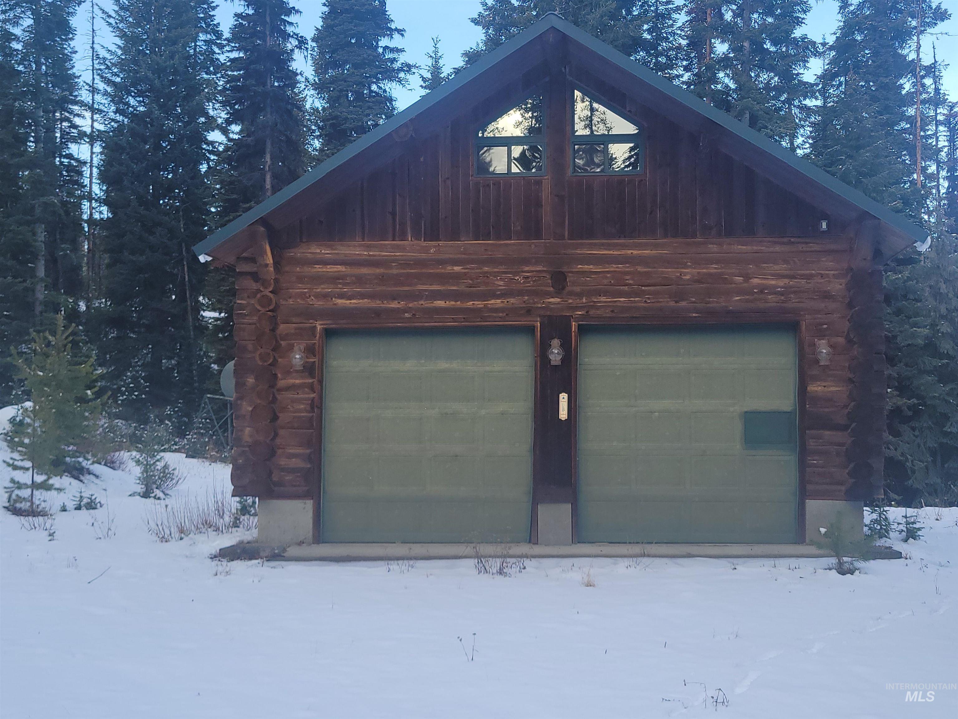 129 Copperhead Road Elk City, ID 83525 - Photo 8 of 28 Snow covered garage with a garage