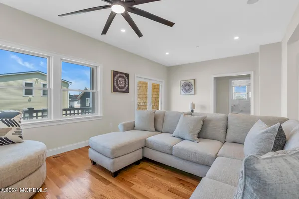 a view of a bedroom with a bed and ceiling fan