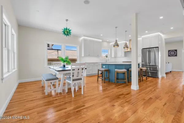 a kitchen with a table chairs and wooden floors