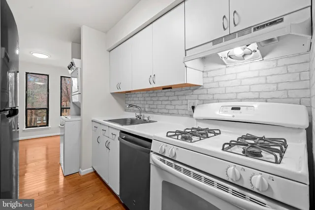 a white stove top oven sitting inside of a kitchen
