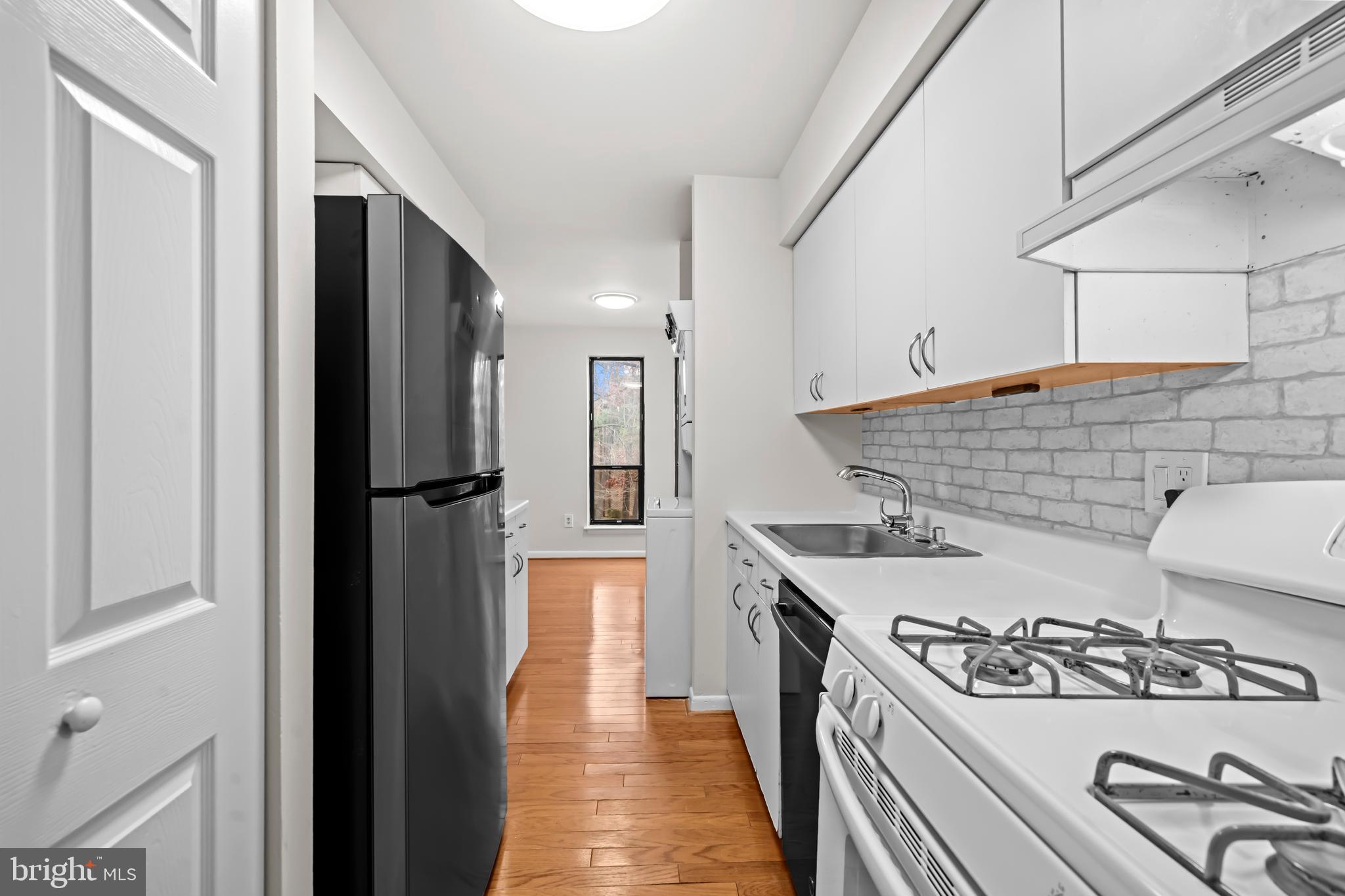11200 Chestnut Grove Square, Unit 203 Reston, VA 20190 - Photo 15 of 41 a kitchen with a stove and a refrigerator
